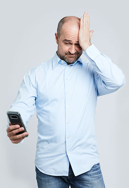 Peter Myers holding a mobile phone